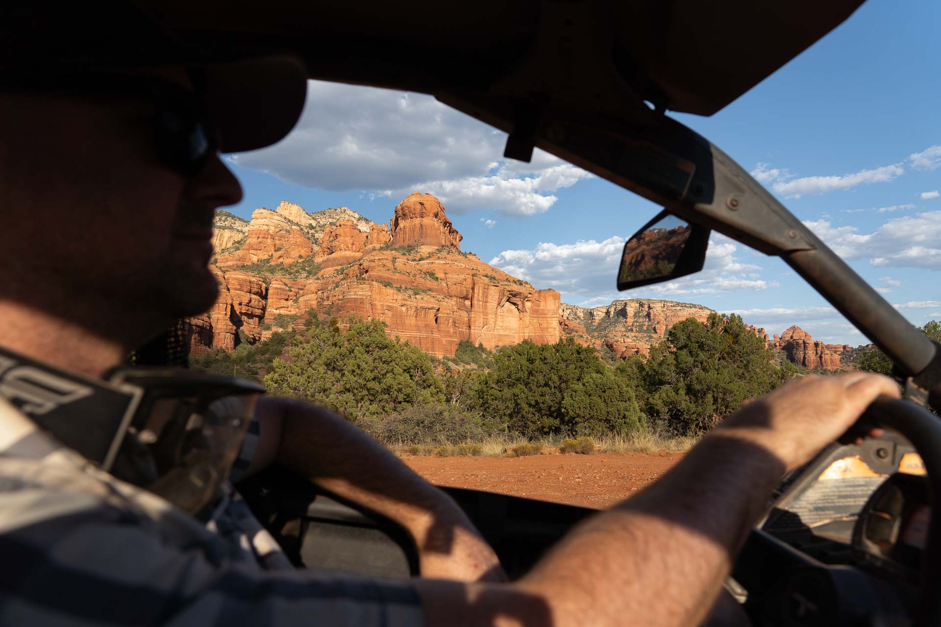 Red Rocks framed by driver in ATV