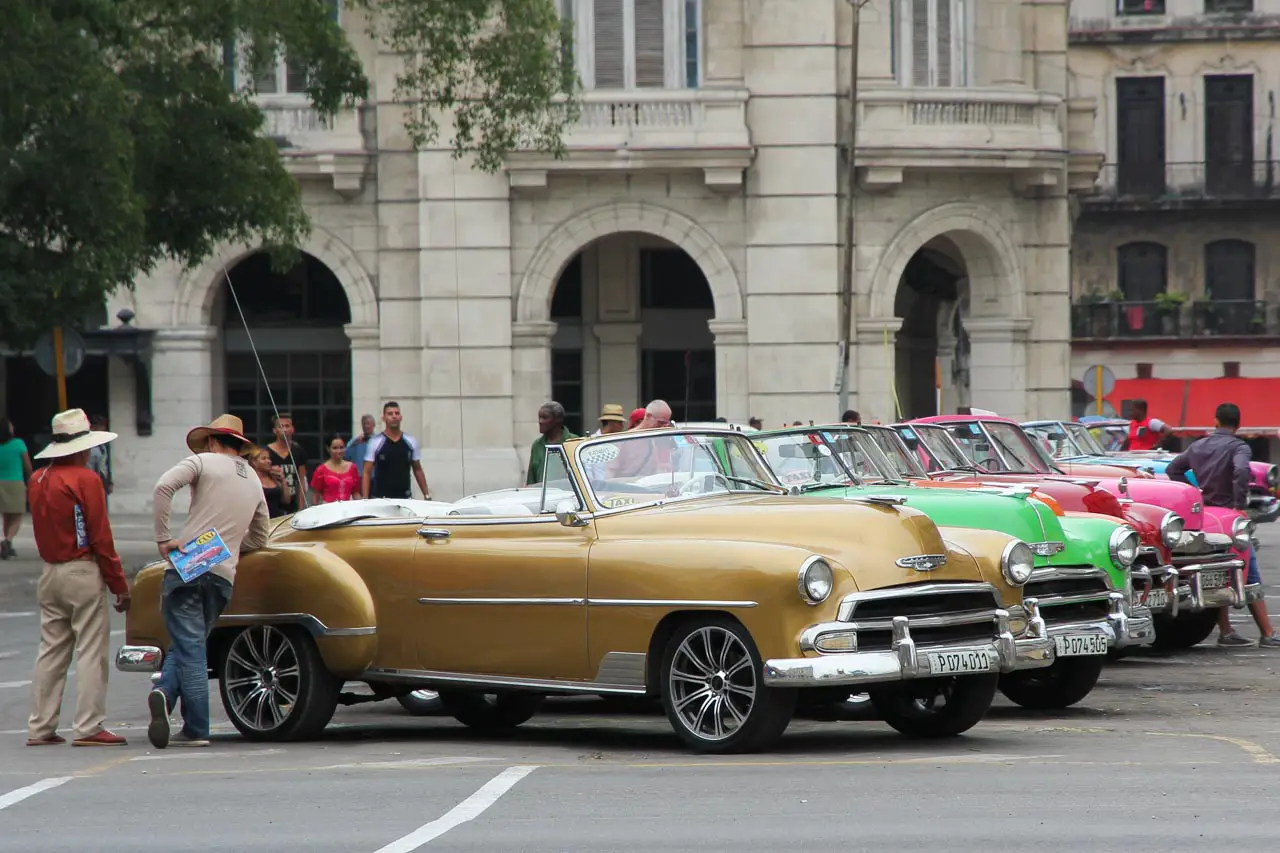 A line up of Classic American cars parked in Havana street