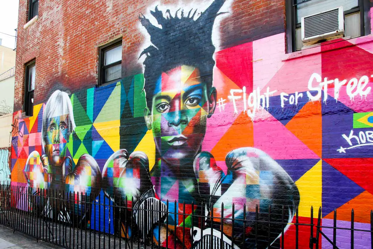 Andy Warhol and Jean-Michel Basquiat wearing boxing gloves in colourful mural by Kobra