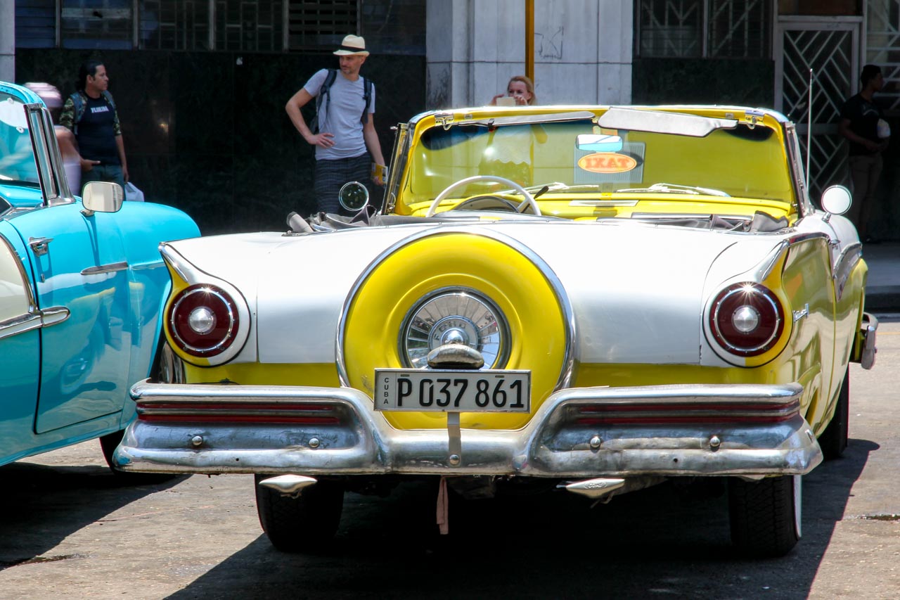 Yellow and white Ford, classic convertible viewed from the rear