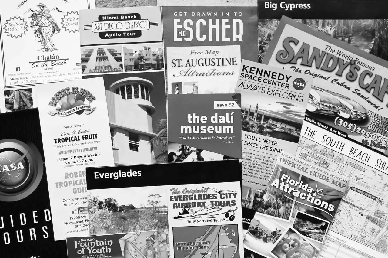Collage of brochures, tickets and maps in black and white
