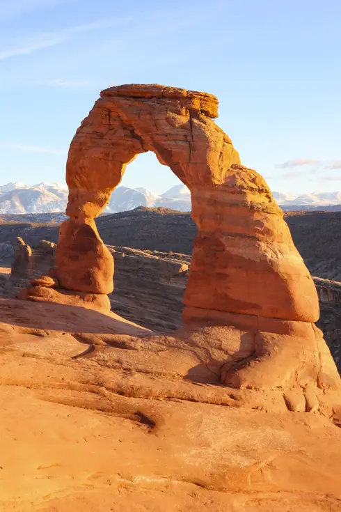 Delicate Arch under a golden sunset glow