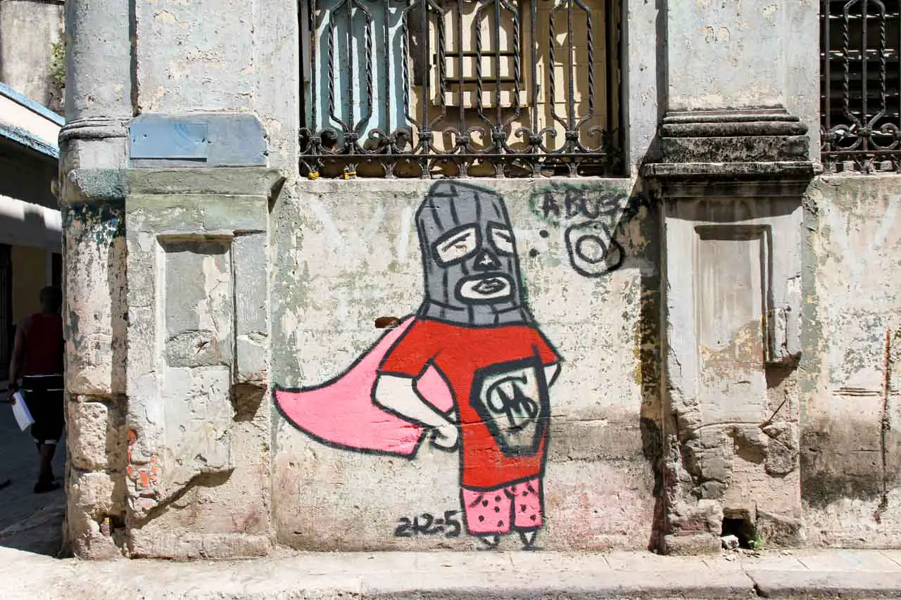 Street art of person in super hero costume and ski mask