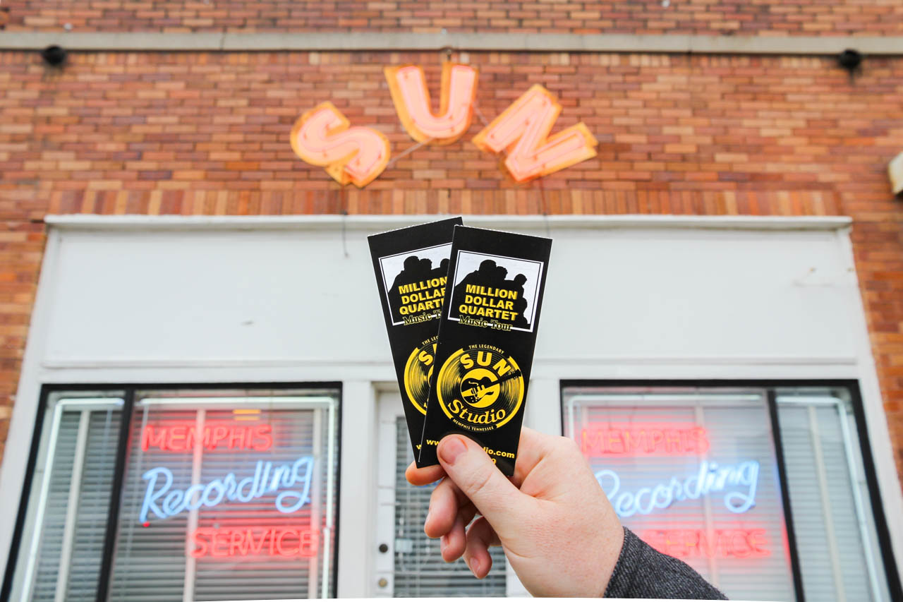 Sun Studio entry with sun sign, and hand holding up two entry tickets