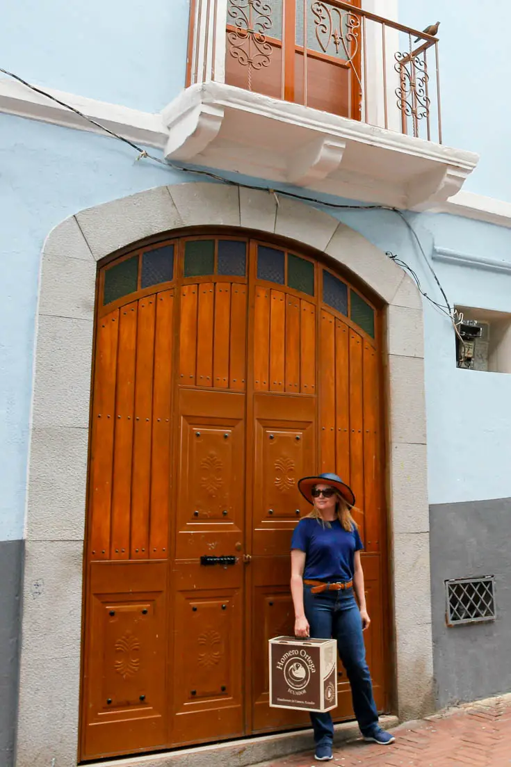 Woman wearing Panama Hat outside large wooden door