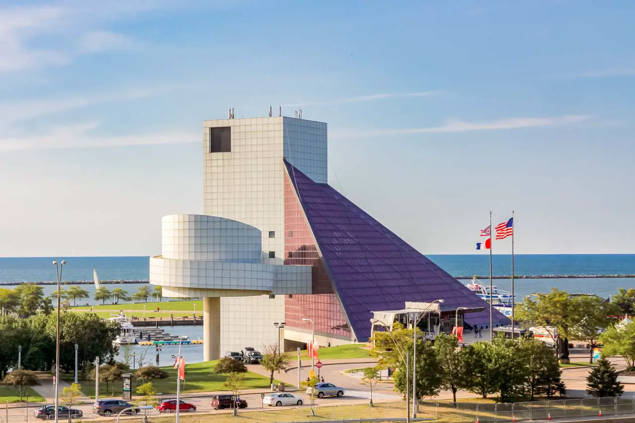Photo of the exterior of Rock & Roll Hall of Fame with Lake Erie in the background.