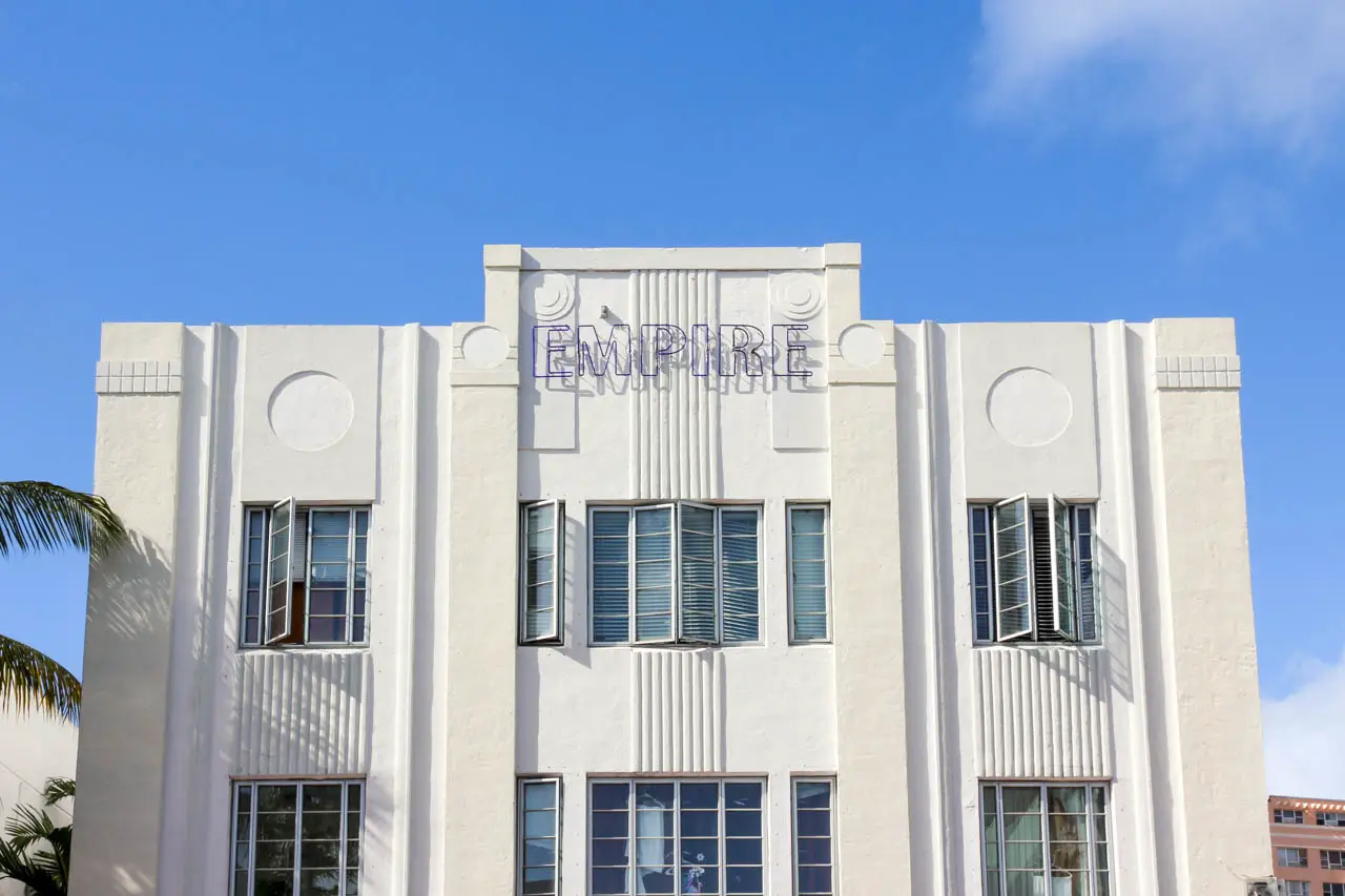 Art deco residential building with neon sign reading "Empire" across front