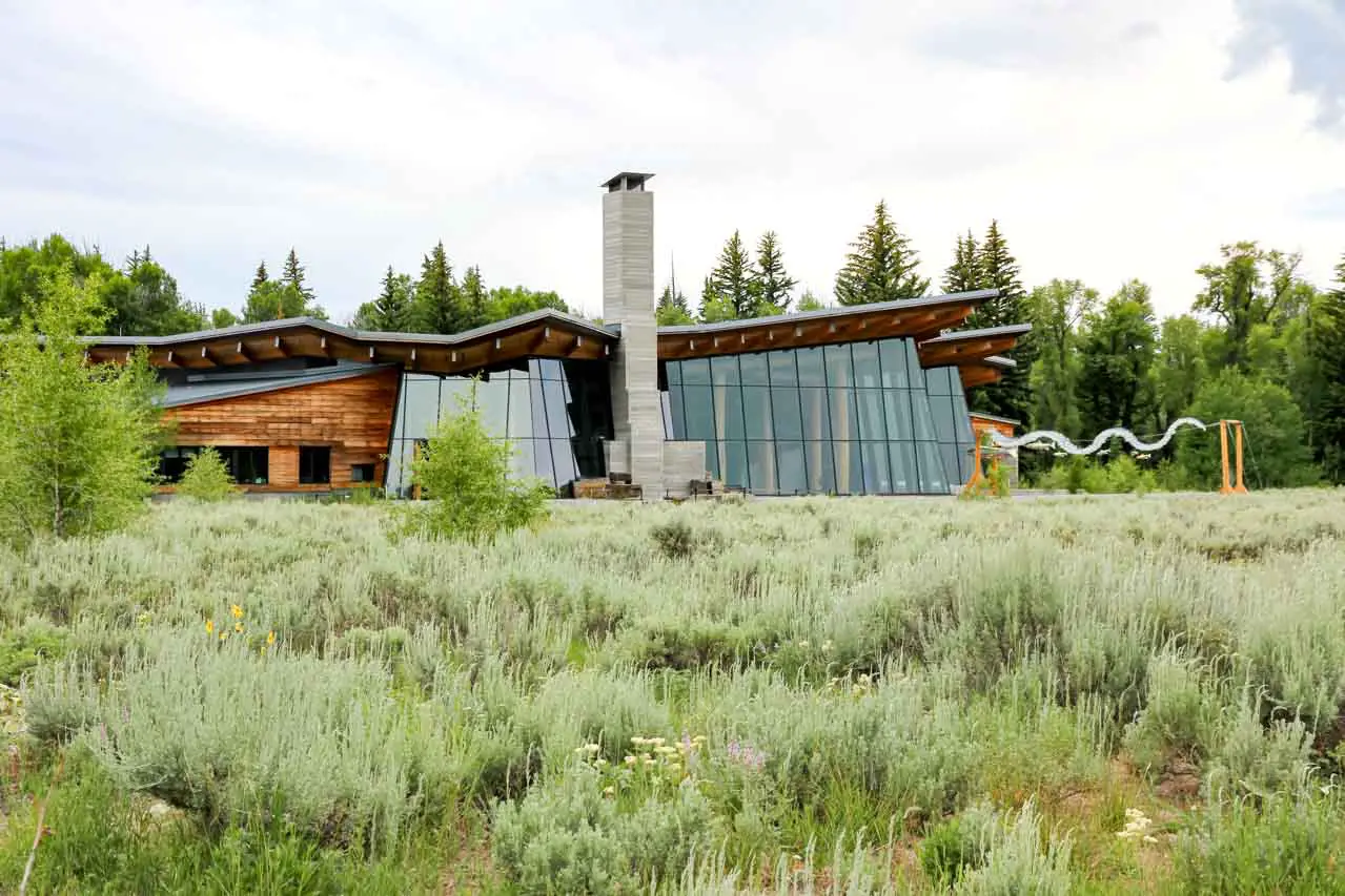 Exterior of Craig Thomas Discovery Center with grasses and shrubs in foreground