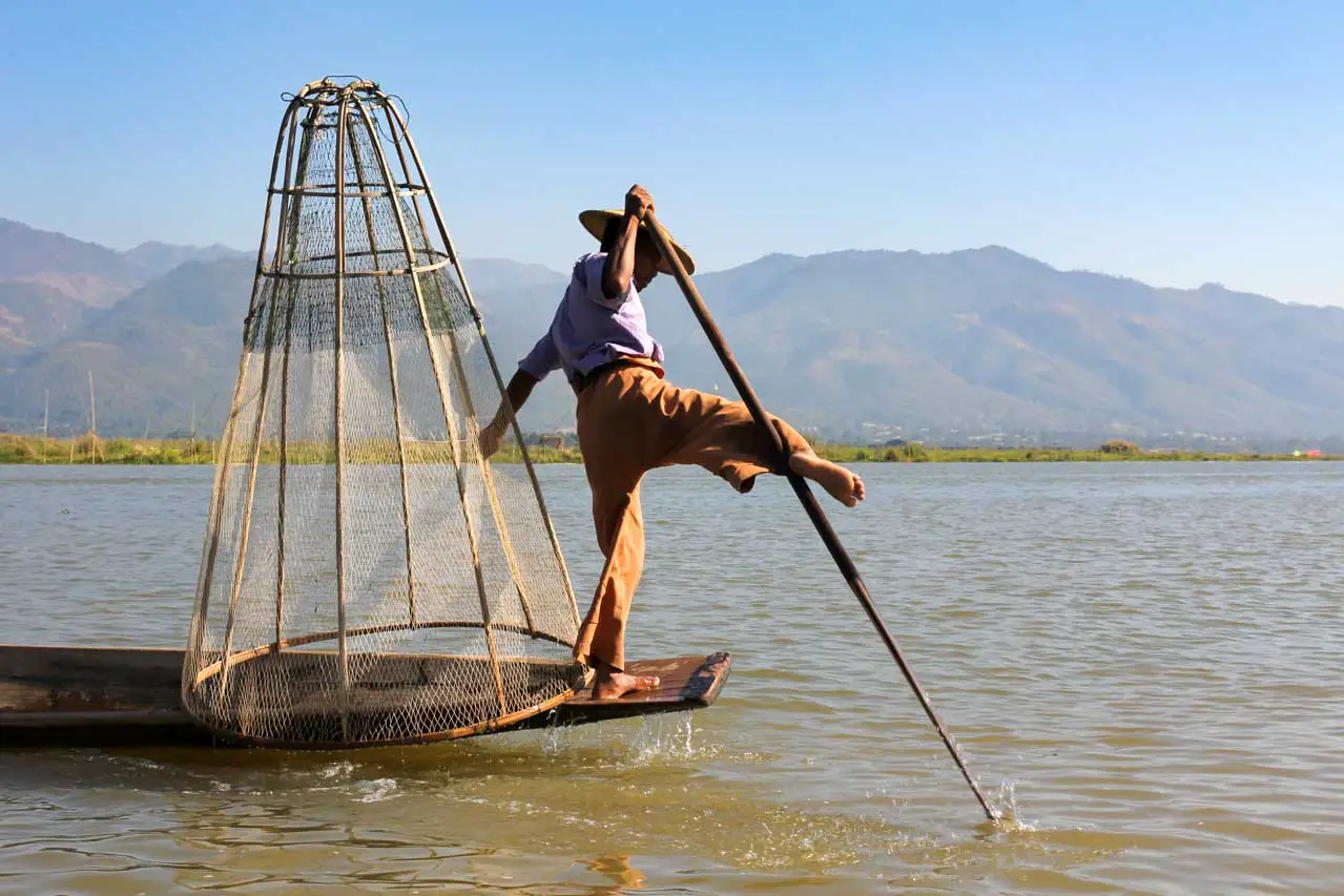 Intha fisherman performing the unique Inle Lake fishing style