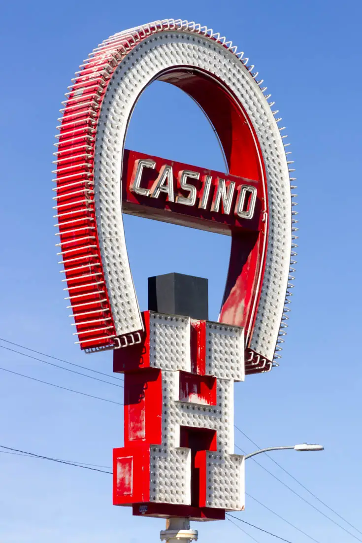 Horseshoe shaped casino sign with large slab-serif "H"