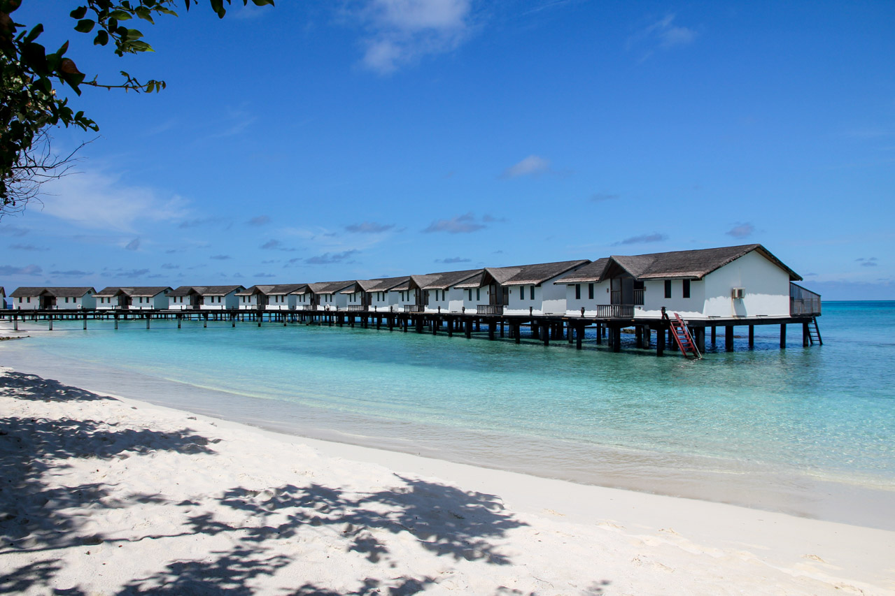 Overwater bungalows viewed from white-sand beach
