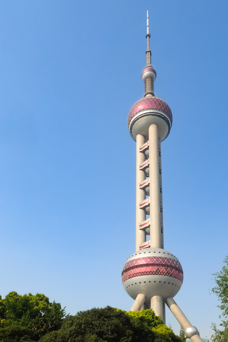 Oriental Pearl Tower on a sunny day, viewed against clear blue skies