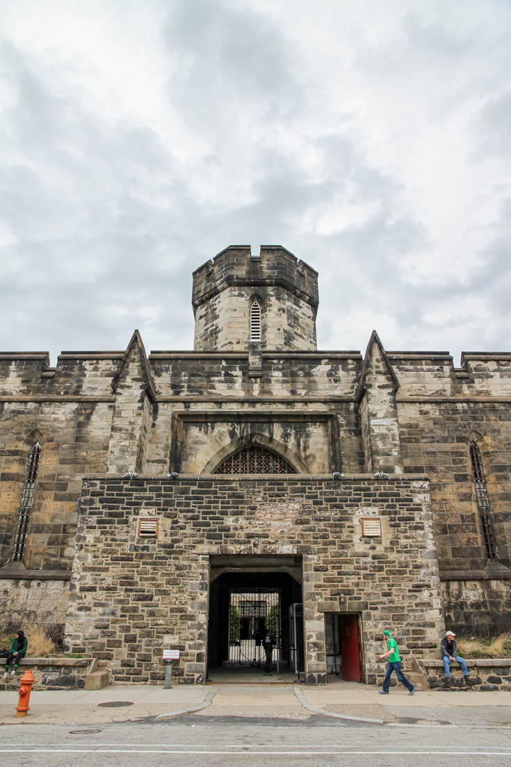 A fortress-like entry with stone walls and watchtower