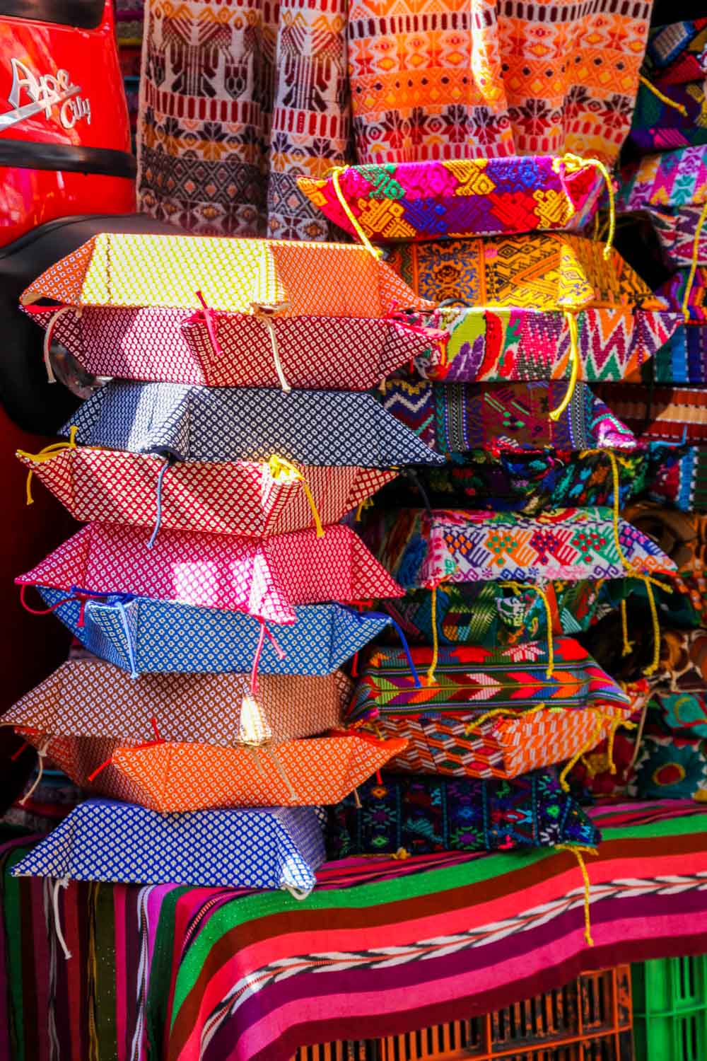 Colourful folding bread baskets pstacked on a market table