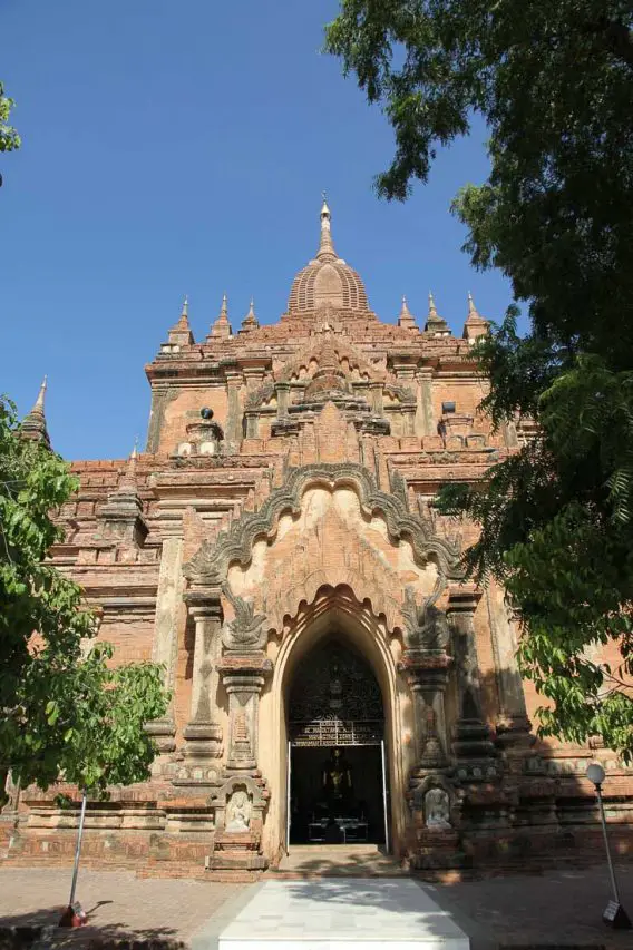 Front facade of a red-brick Buddhist temple in Bagan