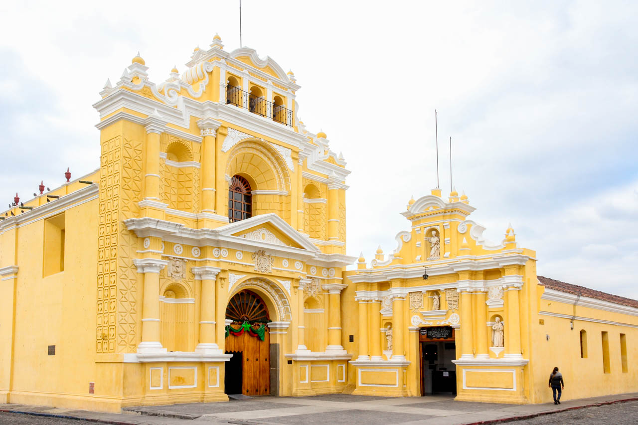 Buttery yellow church and hospital buildings in baroque style