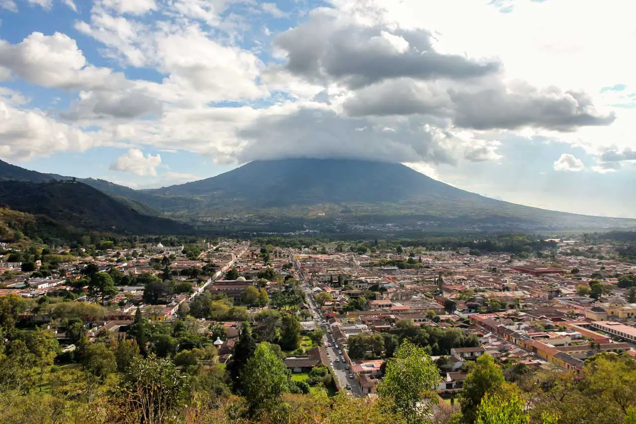 Clouds resting on Volcán de Agua in background with the city of Antigua in foreground