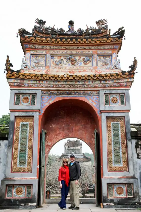 Couple standing in archway at Tu Duc Tomb, Hue