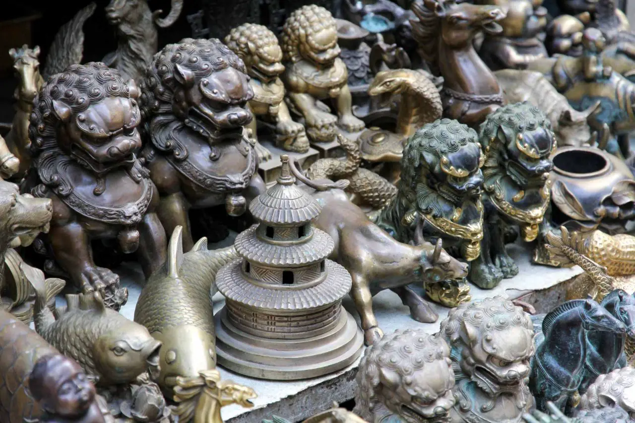 Fu dogs, carp and pagoda figurines on table