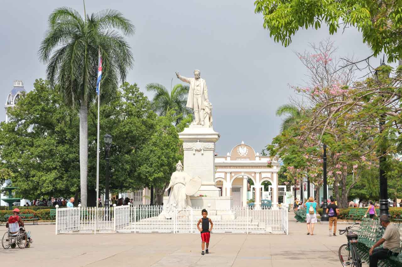 Monument to José Martí Park in park with young boy, man in wheelchair and park bench in foreground