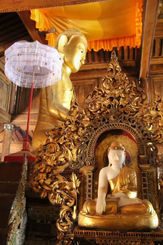 Buddha images in gold with white parasol