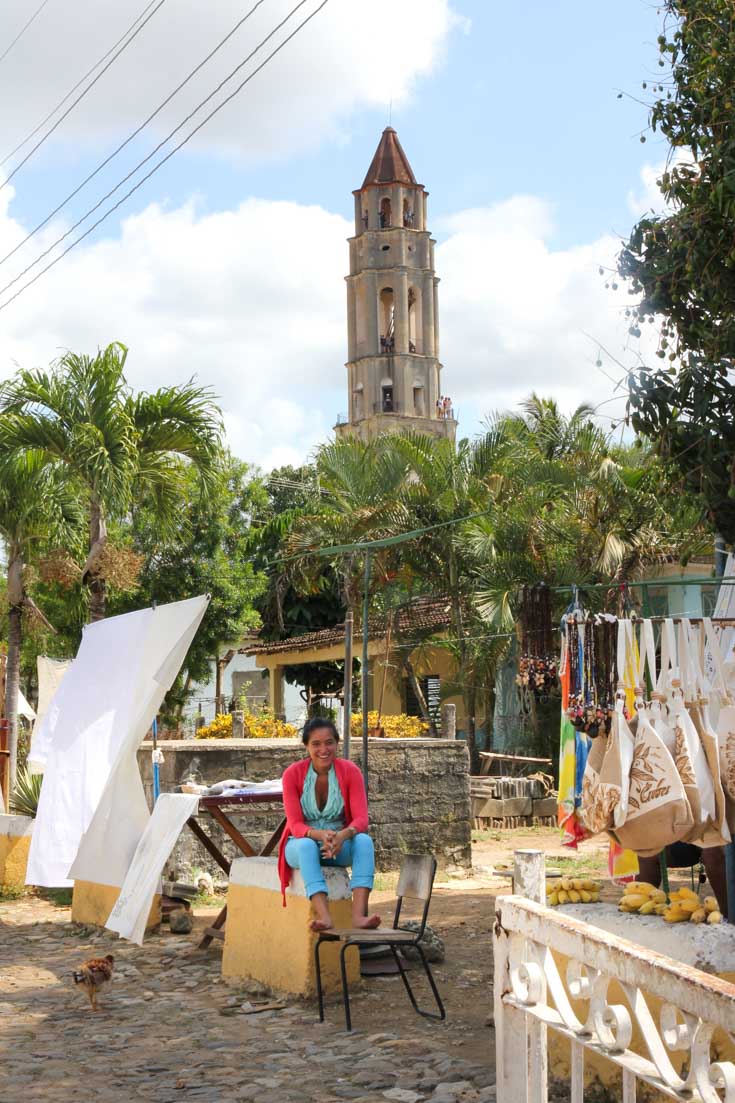 Colonial sugar plantation watchtower with woman selling souvenirs at market in foreground
