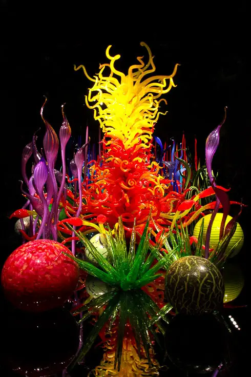 Colourful glass sculptures illuminated in a dark room