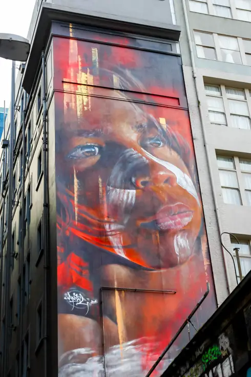 Mural on side of building depicting a portrait of a young Aboriginal boy
