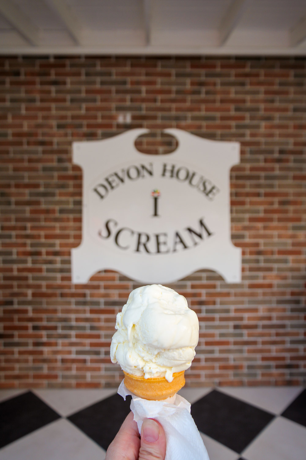 Ice cream being held up infront of Devon House I-Scream sign