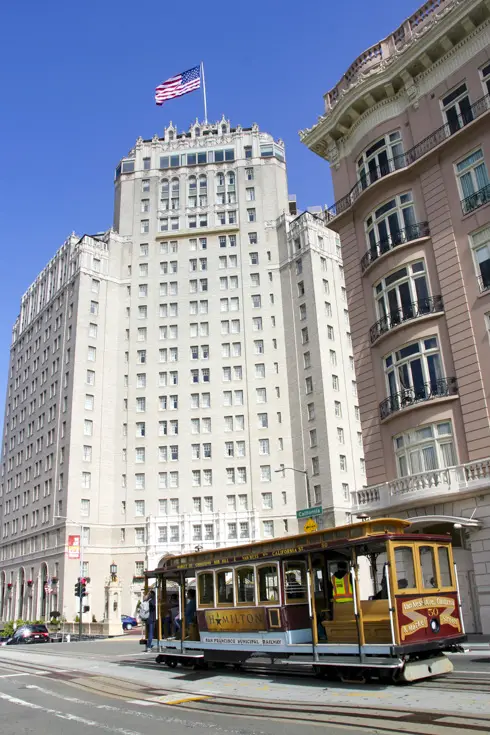 California St Cable Car passing the heritage hotel