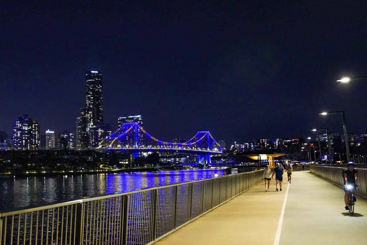 New Farm City Walk at night with Story Bridge lit up in blue in the background