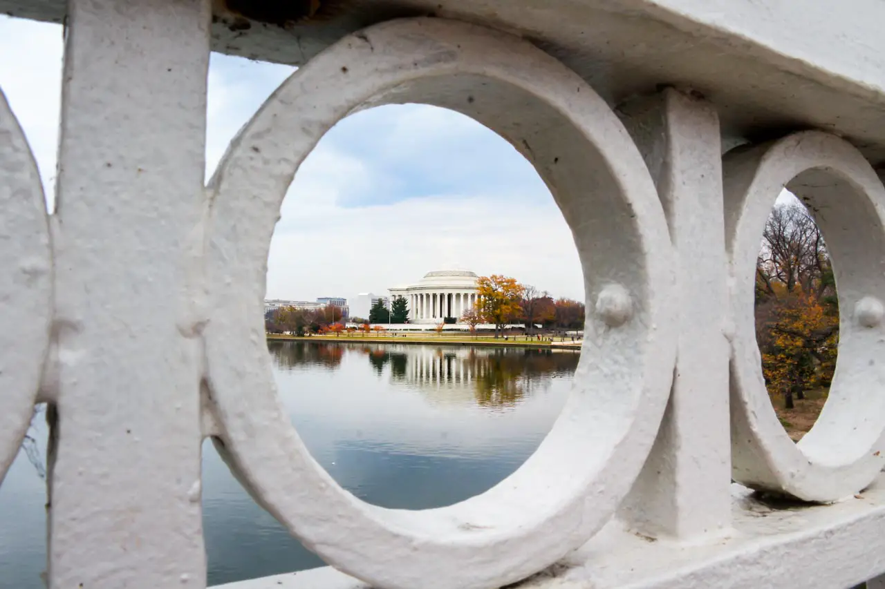 Thomas Jefferson Memorial viewed through the decorative railings of a bridge and across the tidal basin