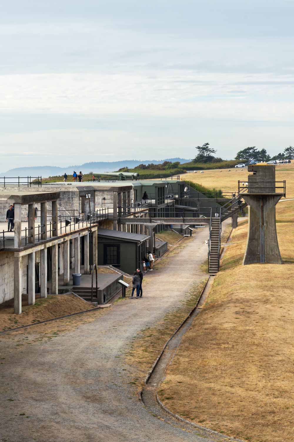 Concrete fortifications of a military fort near the water with grey clouds