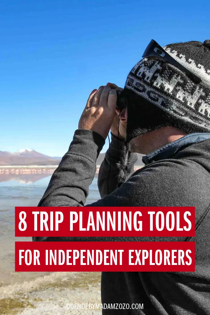 Image of man looking through binoculars at mountain lake with title overlay reading "8 trip planning tools for independent explorers"