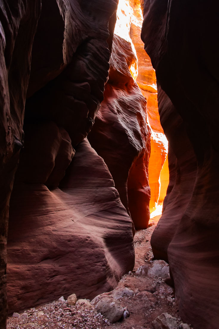 Sunlight illuminating a slot canyon in vibrant orange