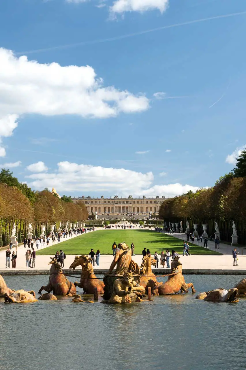 View of Château de Versailles from its gardens with Apollo's Fountain in the foreground
