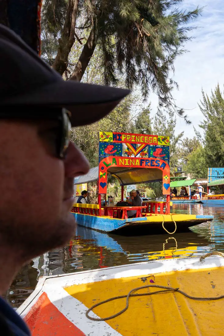 Man looking out at trajineras of Xochimilco