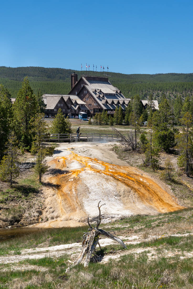 Old Faithful Inn viewed across the colours of Upper Geyser Basin