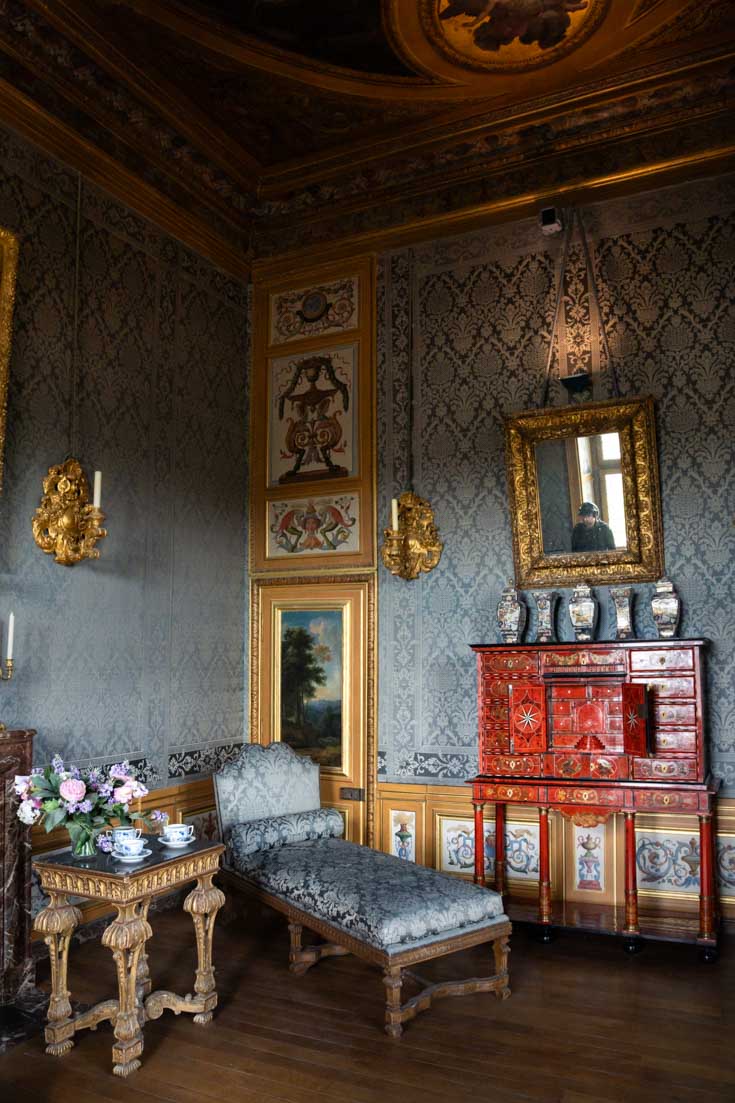 Lavish interior details including hand-painted wall panels, damask wall coverings and antique furniture