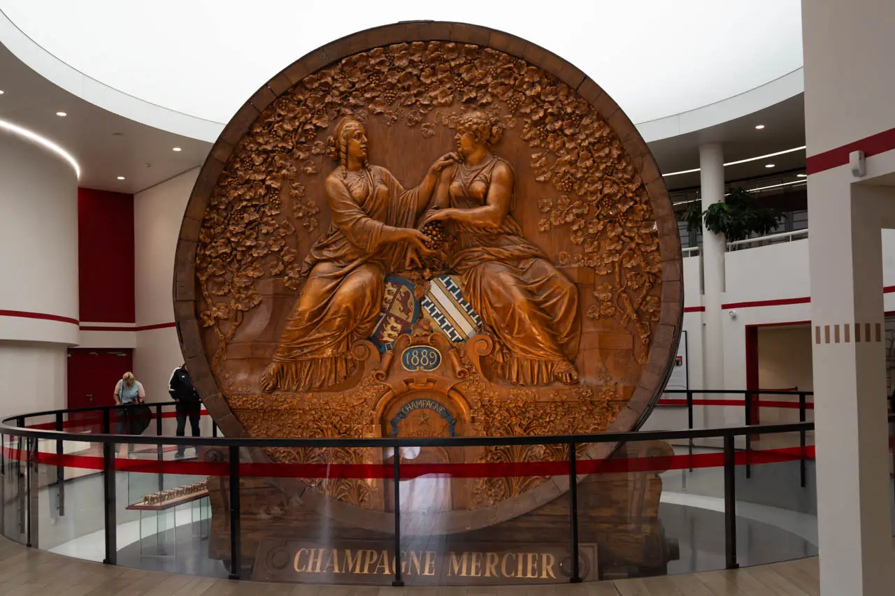 A giant oak wine cask, intricately carved with figures of two women