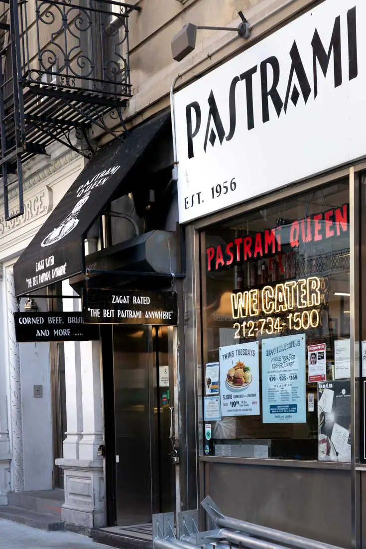 Photo os shopfront with illuminated sign saying "Pastrami Queen"