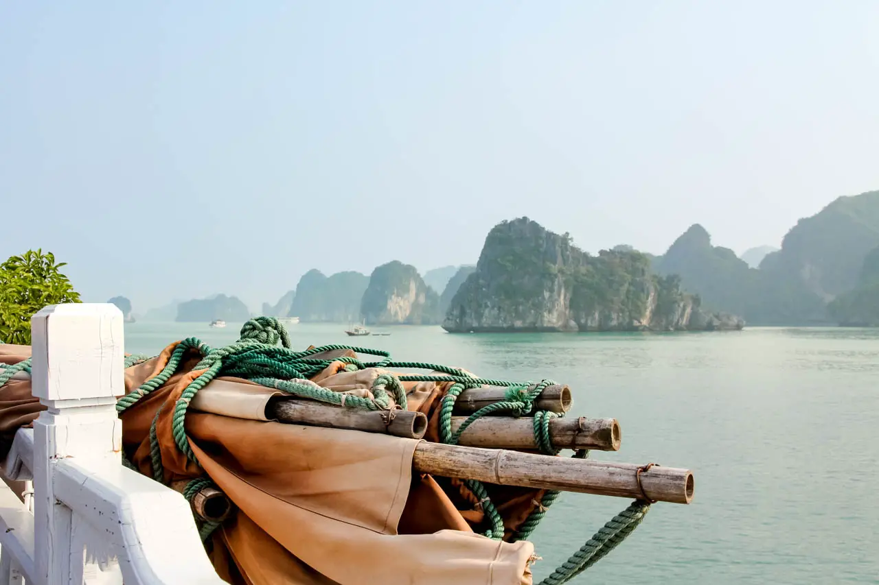 Islands of Ha Long Bay with ship rigging in foreground