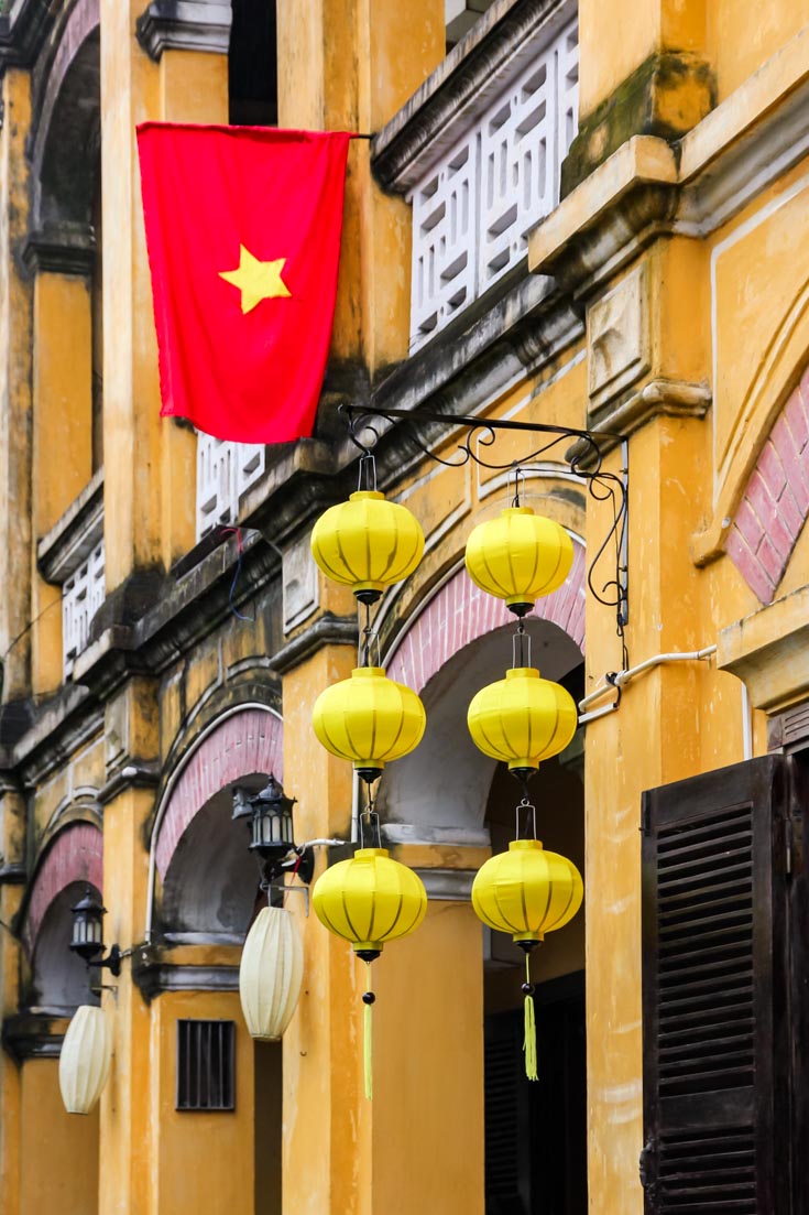 Yellow colonial shopfronts with national flag and silk lanterns