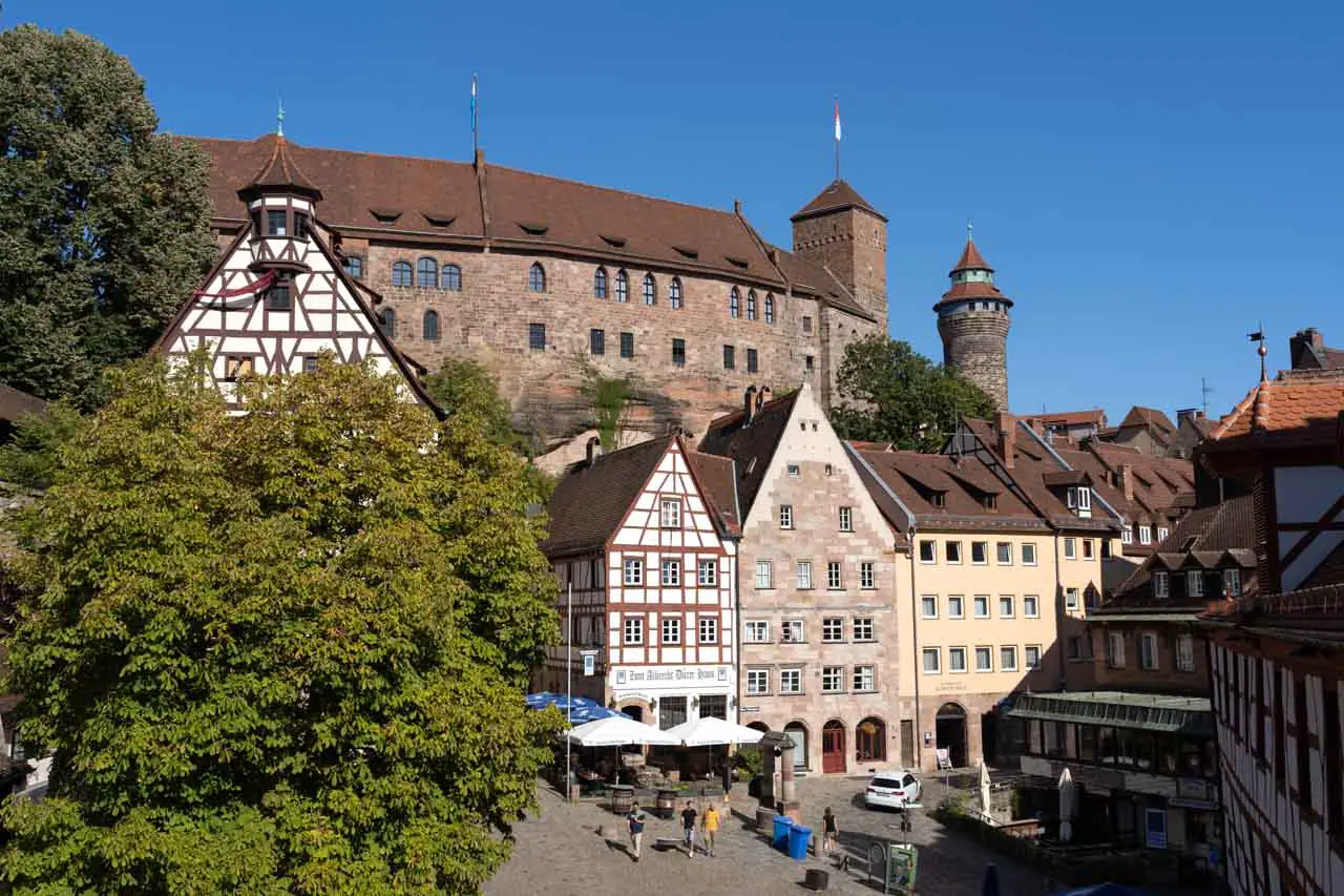 Nürnberg Imperial Castle on hilltop with medieval-style houses in the foreground