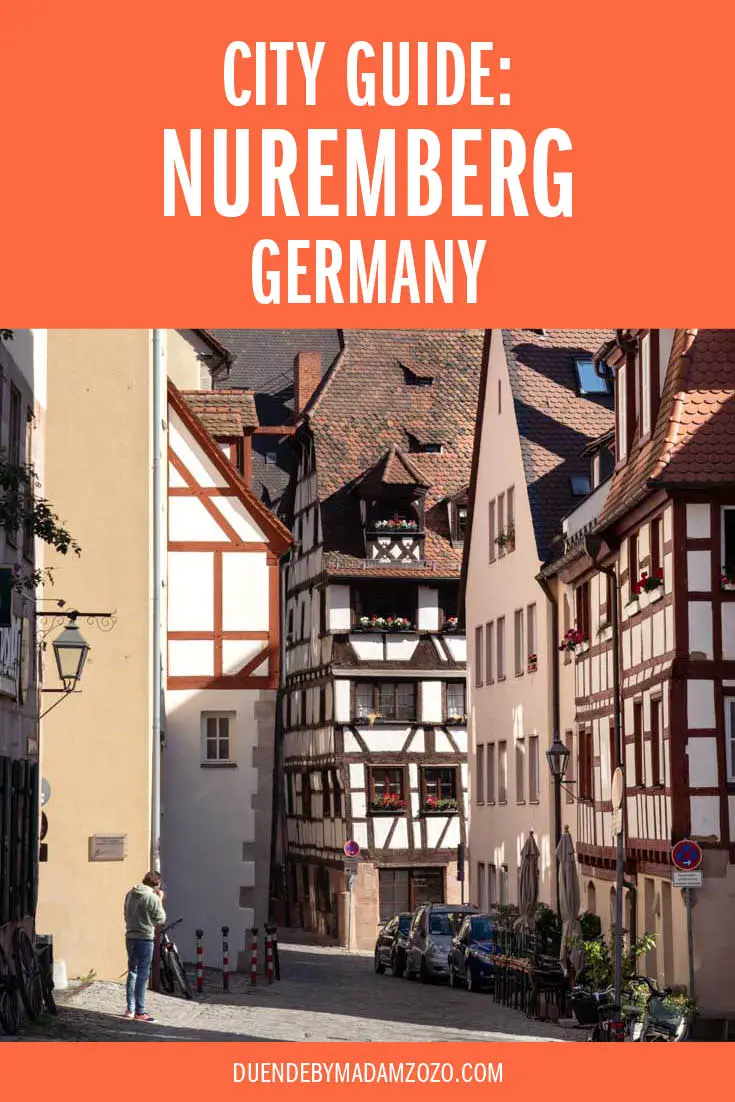 Image of street lined with half-timbered houses and text overlay reading "City Guide: Nuremberg, Germany"