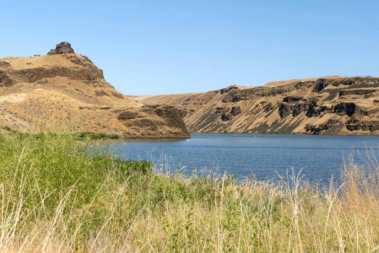 Confluence of two large rivers surrounded by semi-arid cliffs and vegetation