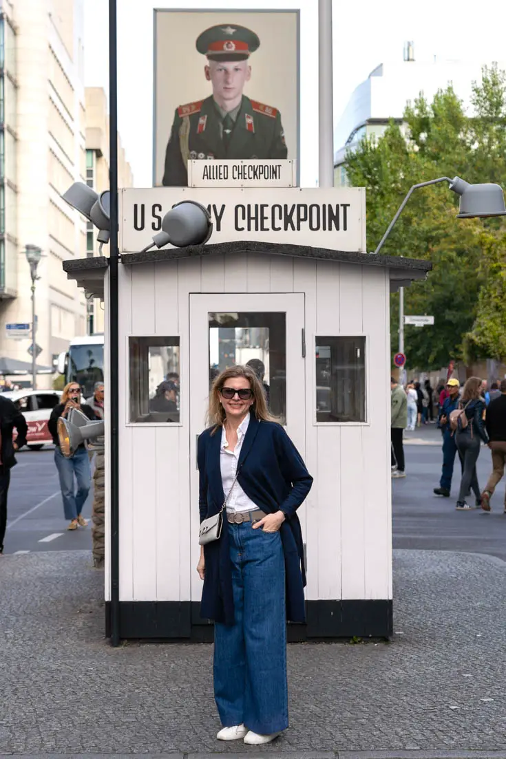 Woman standing infront of Checkpoint Charlie