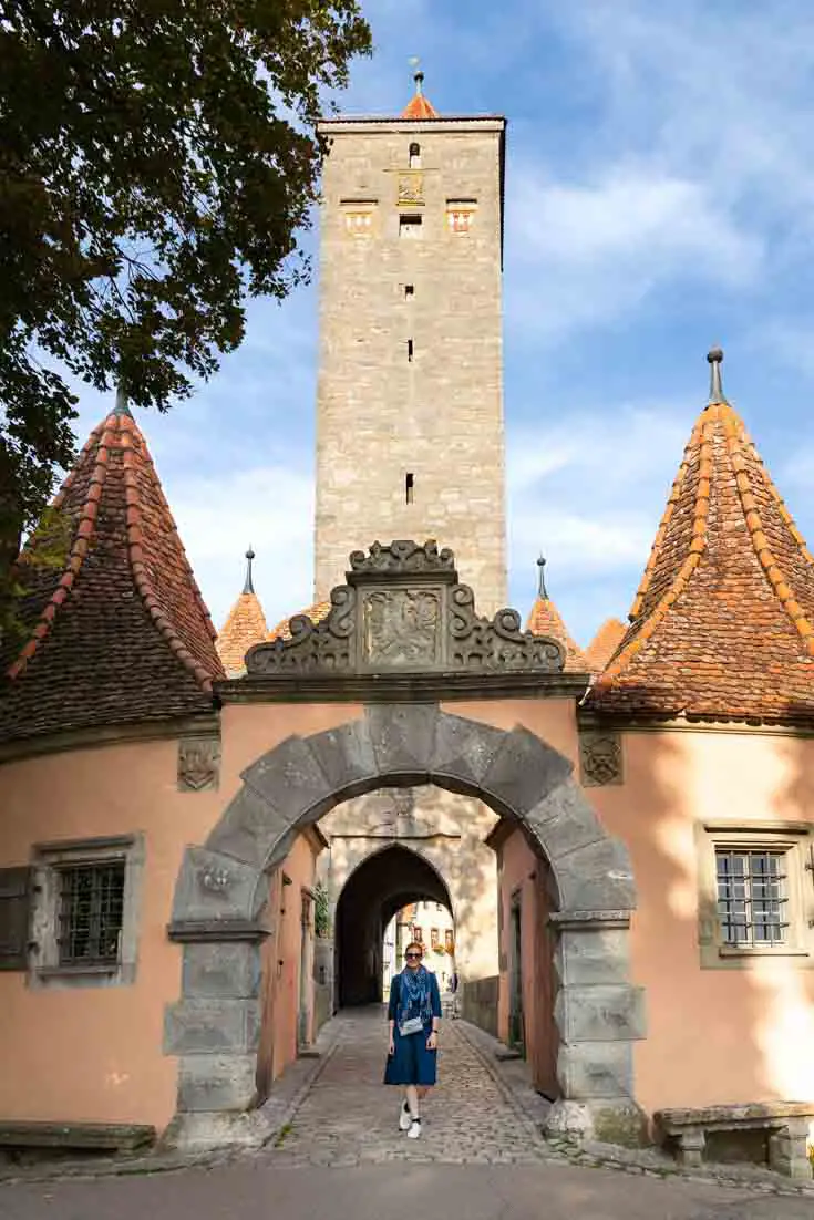 Woman standing in arched gate in Rothenburg
