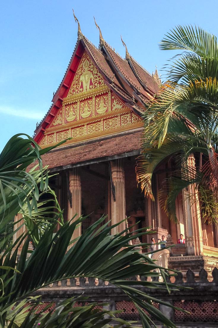 Reconstructed temple exterior viewed through palm fronds