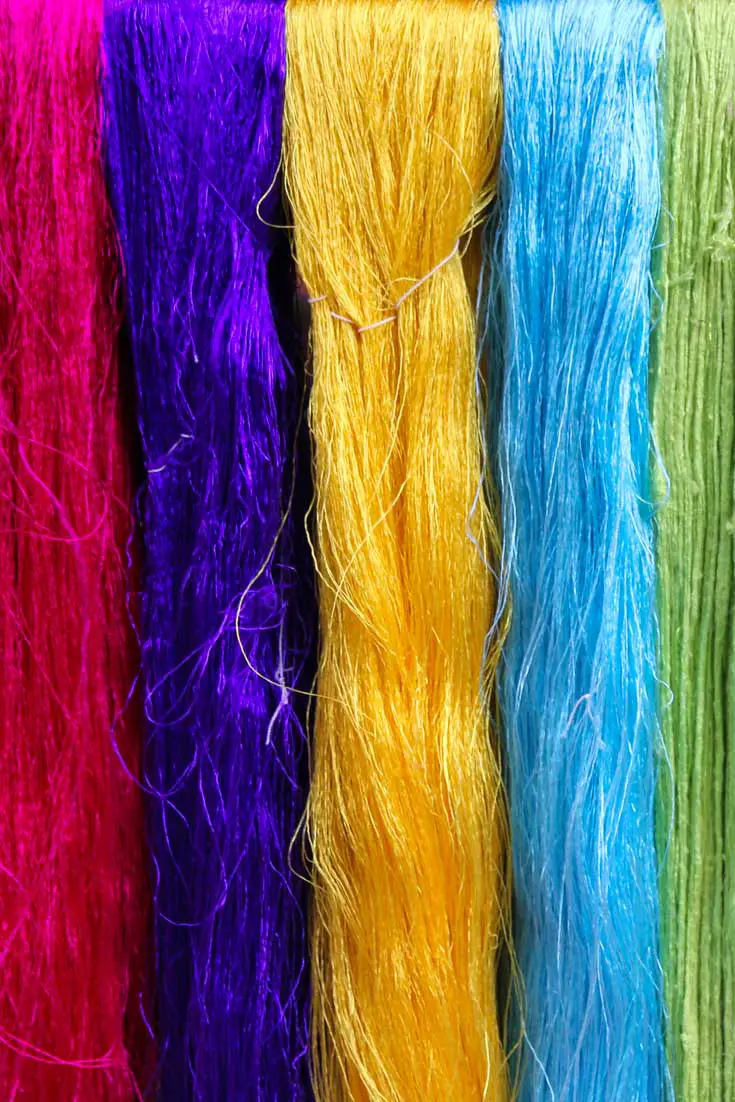 Bundles of dyed silk strands in pink, purple, yellow, sky blue and chartreuse
